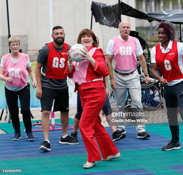 Nicky Morgan, Secretary of State for Digital, Culture, Media and Sport plays netball during the Birmingham 2022 Commonwealth Games celebrates...