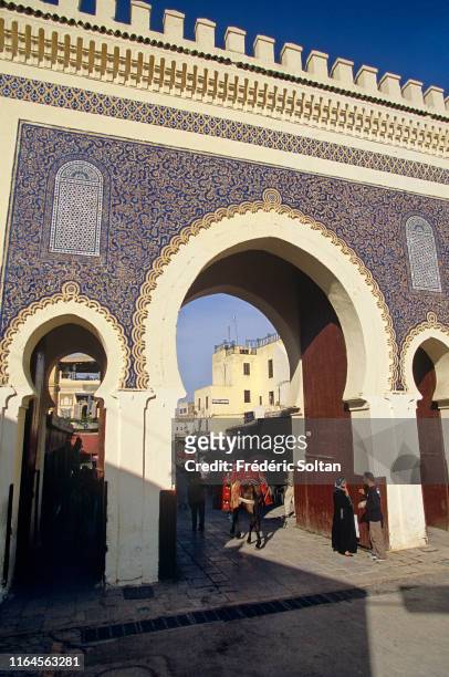 Traditional Moroccan street market or souk in the old part of Fez Medina, view of Bab Boujeloud on June 20, 2019 in Fez, Morocco.