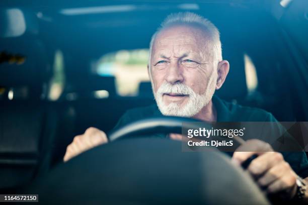 senior man having bad eye sight and making effort to see the road. - problems imagens e fotografias de stock