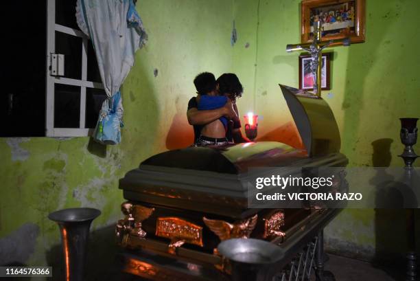 Family members cry over the coffin of Xochitl Nayeli Irineo Gomez one of the victims of the attack at the Caballo Blanco bar, on August 28 in...