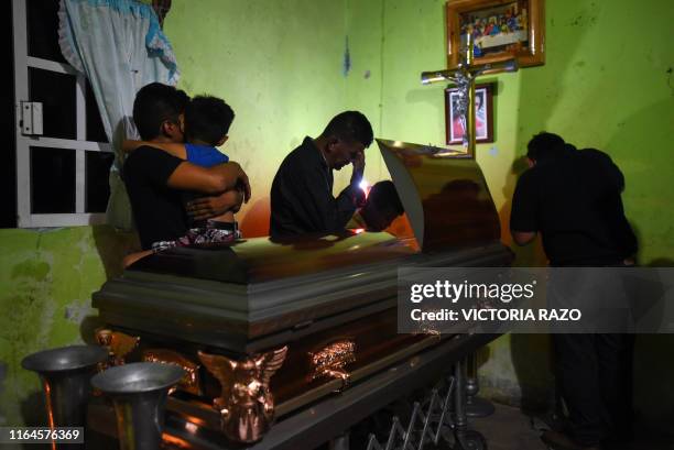 Family members cry over the coffin of Xochitl Nayeli Irineo Gomez one of the victims of the attack at the Caballo Blanco bar, on August 28 in...