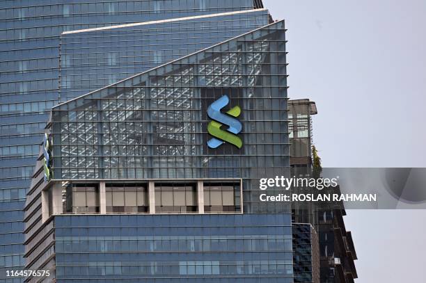 Standard Chartered Bank logo is displayed on a building in Singapore on August 29, 2019.