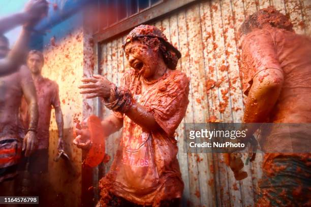 Revellers are covered with smashed tomato puree during the 'Tomatina' festival in Bunol, Valencia, Spain, on 28 August 2019. This iconic annual...