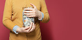 Jar full of money in hands. Saving money concept