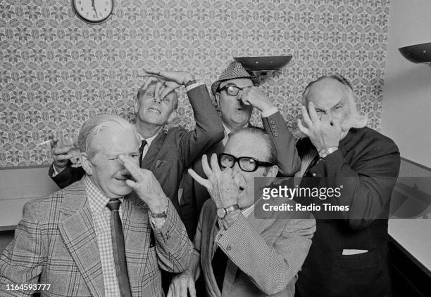 Comedians Ted Ray, McDonald Hobley, Cyril Fletcher, Jimmy Edwards and Arthur Askey joking around together during a recording for the BBC Radio 4...