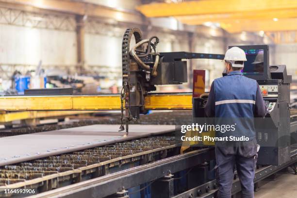 steel worker on cnc plasma cutter machine - cnc cutting stock pictures, royalty-free photos & images