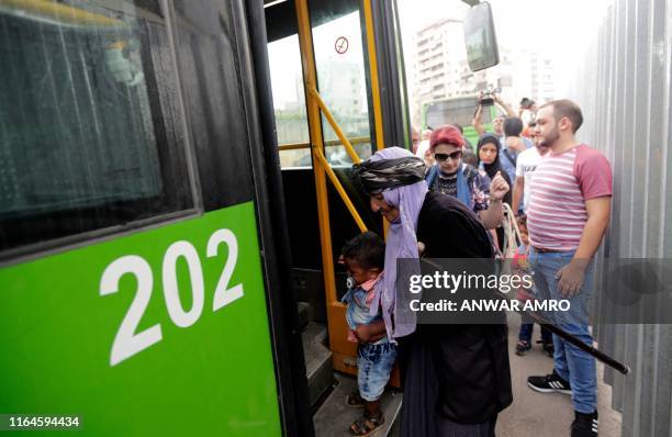 Syrian refugees board a bus in the Beirut suburb of Burj Hammoud, north of the capital on August 29 as they prepare to return home to neighbouring...