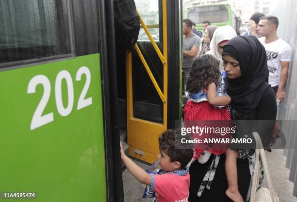 Syrian refugees board buses in the Beirut suburb of Burj Hammoud, north of the capital on August 29 as they prepare to return to neighbouring Syria.