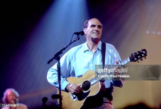American Folk musician James Taylor plays acoustic guitar as he performs onstage at the Rosemont Theater, Rosemont, Illinois, August 30, 2001.