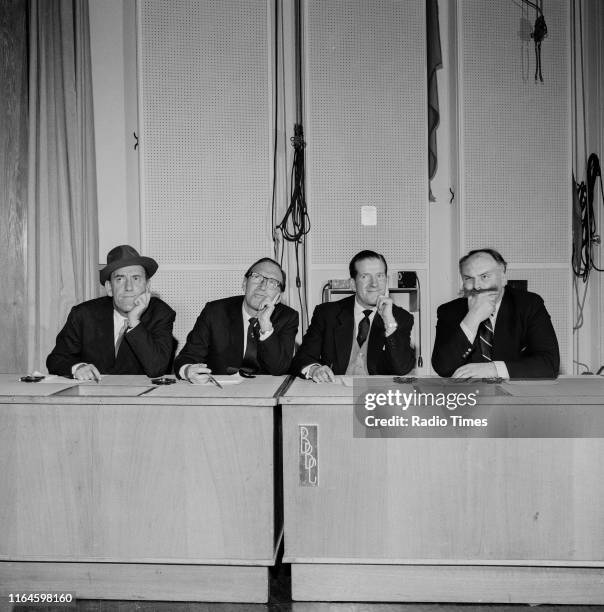 Comedians Tommy Trinder, Arthur Askey, Ted Ray and Jimmy Edwards sitting behind a desk during a recording for the BBC Radio 4 comedy series 'Does the...