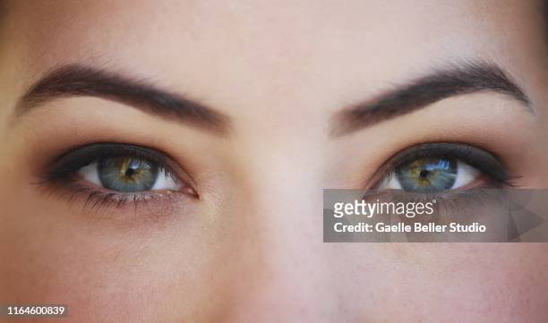 close up of a woman's green eyes - smoky eye stock pictures, royalty-free photos & images