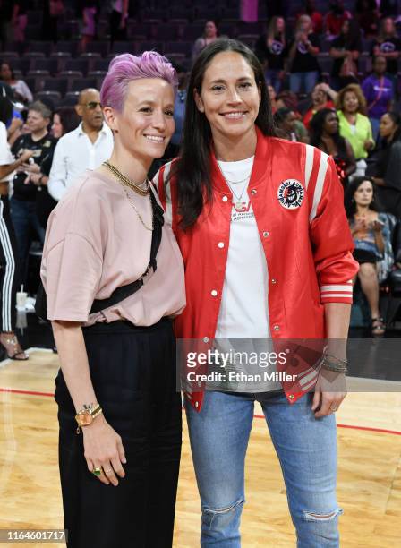 Soccer player Megan Rapinoe and Sue Bird of the Seattle Storm pose for photos on the court after attending the WNBA All-Star Game 2019 at the...