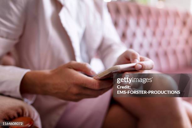 woman is texting on smartphone - broken phone stock-fotos und bilder