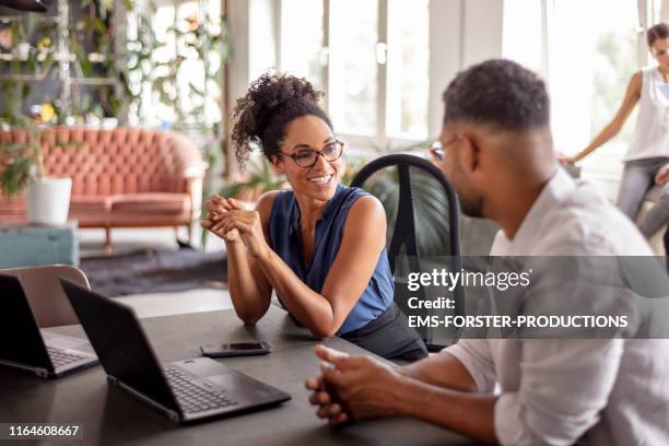 businessman looking at female manager in her office - broken trust stock pictures, royalty-free photos & images