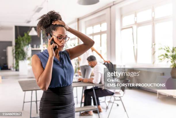 female manager using mobile phone in her office - broken trust stock pictures, royalty-free photos & images