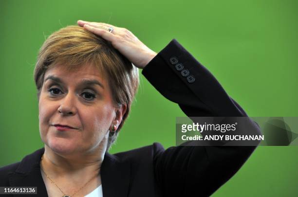 Scotland's First Minister, and leader of the Scottish National Party , Nicola Sturgeon, reacts during a visit to the University of Strathclyde's...