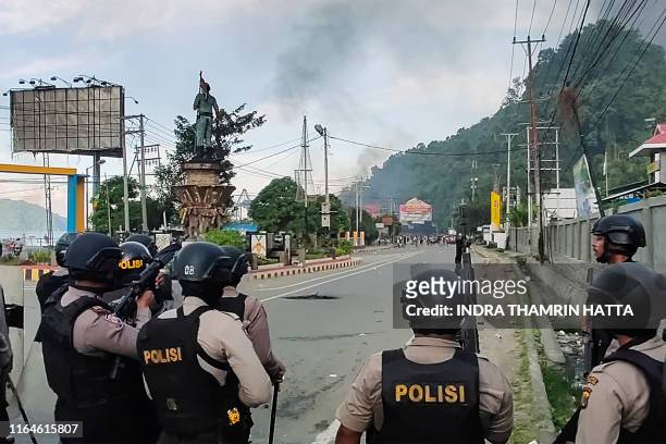 Indonesian security forces take position along a street after hundreds of demonstrators marched near Papua's biggest city Jayapura on August 29 where...
