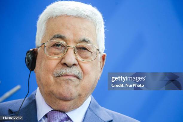 Palestinian President Mahmoud Abbas reacts while speaking to the media with German Chancellor Angela Merkel ahead of a common meeting at the...