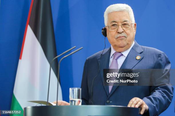 Palestinian President Mahmoud Abbas reacts while speaking to the media with German Chancellor Angela Merkel ahead of a common meeting at the...