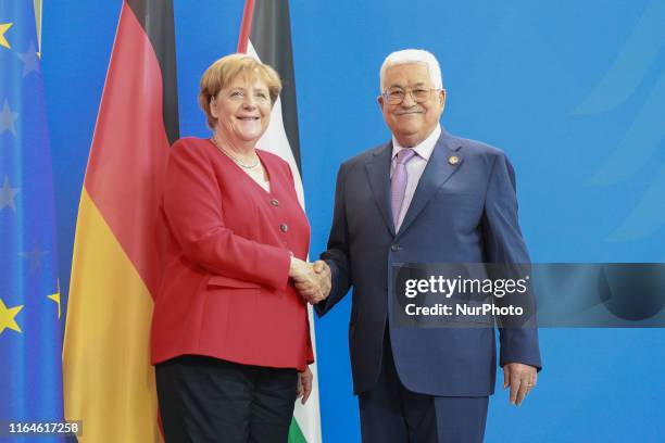 German Chancellor Angela Merkel and Palestinian President Mahmoud Abbas shaking hands after a statement ahead of a common meeting at the Chancellory...