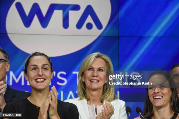 Micky Lawler, president of the Women's Tennis Association, applauds with other members of the WTA and tennis players Gaby Dabrowski and Nicole Gibbs...
