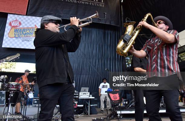 Asdrubal Sierra and Ulises Bella of Ozomatli perform during the Vans Warped Tour 25th Anniversary on July 20, 2019 in Mountain View, California.