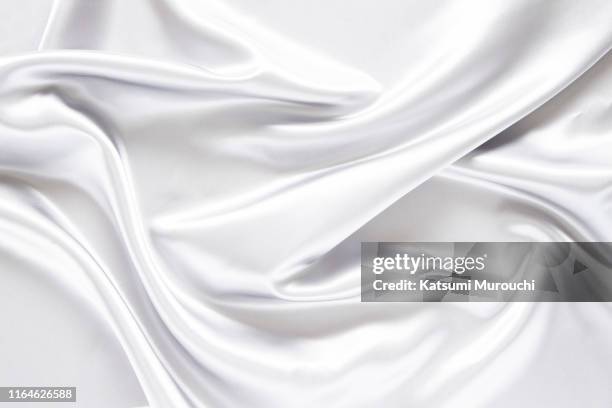 white satin textured background material - silk cloth stock pictures, royalty-free photos & images