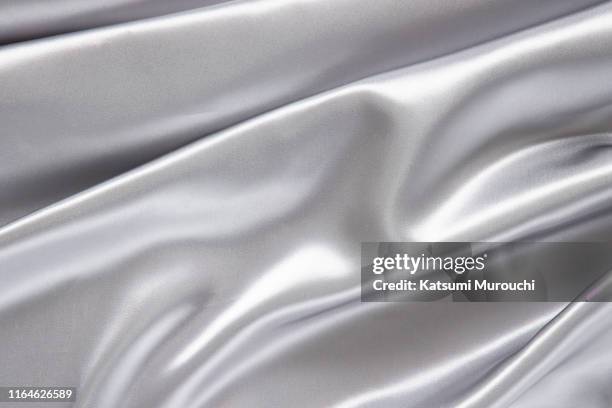 silver satin textured background material - silver colored stock pictures, royalty-free photos & images