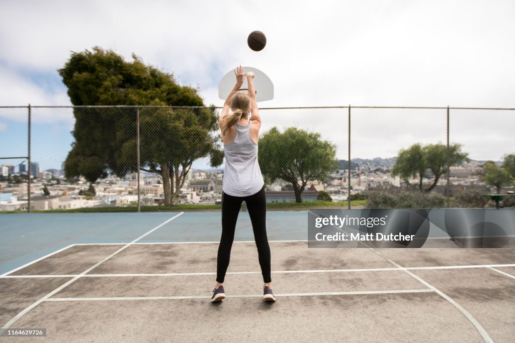 Young woman playing basketball