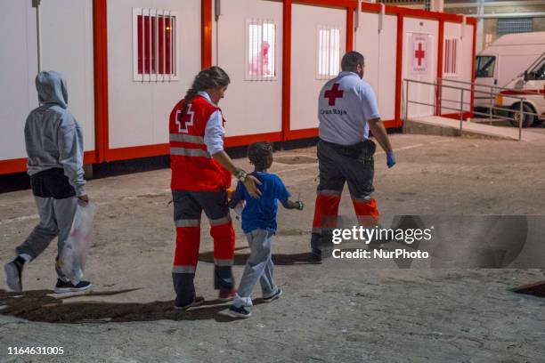 Child with his mother leave the Care unit at the Malaga harbour to be taken to a center on 28 August 2019 inMalaga, Southern of Spain. Two dinghies...