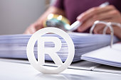 White Registered Trademark Sign Near Documents