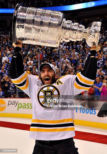 Patrice Bergeron of the Boston Bruins celebrates by hoisting the Stanley Cup after defeating the Vancouver Canucks 4-0 in Game Seven of the 2011 NHL...