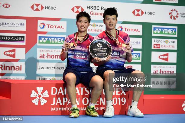 Gold medalists Wang Yi Lyu and Huang Dong Ping of China pose during the medal ceremony of the Mixed Doubles Final match after defeating Praveen...