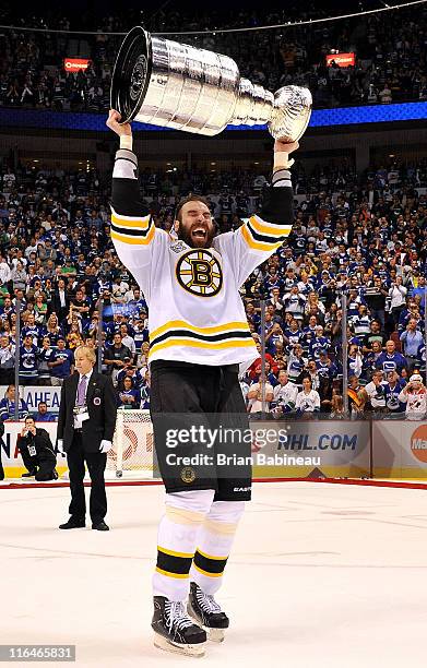 Zdeno Chara of the Boston Bruins lifts the Stanley Cup to celebrate defeating the Vancouver Canucks 4-0 in Game Seven of the 2011 NHL Stanley Cup...