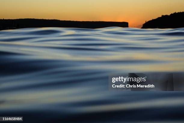 moody calm waters at sunrise - telephoto lens stock pictures, royalty-free photos & images