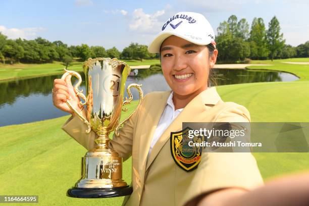 Mone Inami of Japan imitates a selfie after winning the tournament during the final round of the Century 21 Ladies Golf Tournament at Ishizaka Golf...