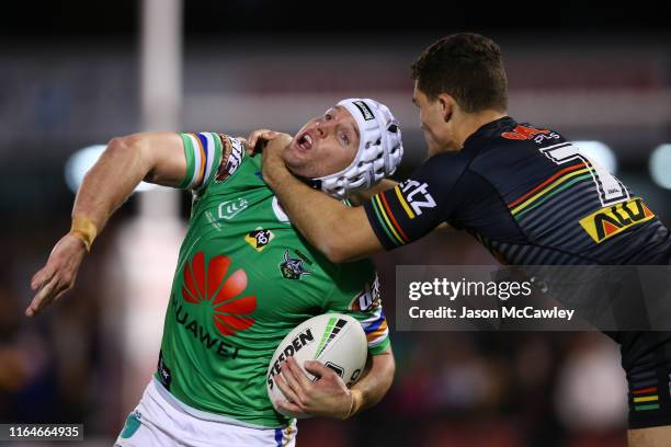 Jarrod Croker of the Raiders is tackled high by Nathan Cleary of the Panthers during the round 19 NRL match between the Panthers and Raiders at...