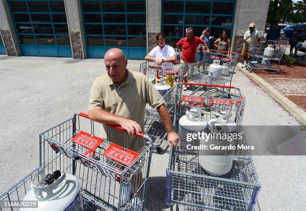 Gary DAngelo and central Florida residents wait on the line to buy propane in preparation for hurricane Dorian at BJ's store on August 29, 2019 in...