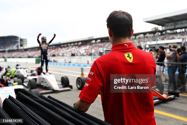 Charles Leclerc of Monaco and Ferrari celebrates after his brother, Arthur Leclerc, won the F4 race before the F1 Grand Prix of Germany at...