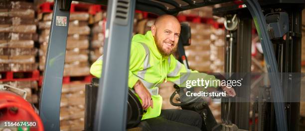 smiling fork lift driver - forklift stock pictures, royalty-free photos & images