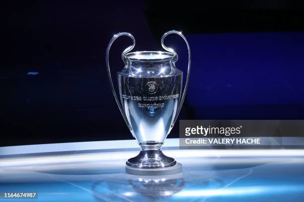 The Champions League Trophy stands on display during the UEFA Champions League football group stage draw ceremony in Monaco on August 29, 2019.