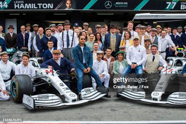 Lewis Hamilton of Mercedes and Great Britain, Valterri Bottas of Mercedes and Finland and Toto Wolff of Mercedes and Germany pose with the team in...