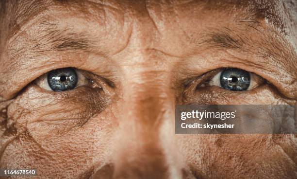 blue-eyed senior man. - extreme close up stock pictures, royalty-free photos & images