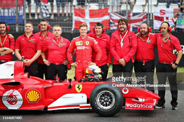 Mick Schumacher of Germany smiles after driving the Ferrari F2004 of his father, Michael Schumacher, before the F1 Grand Prix of Germany at...