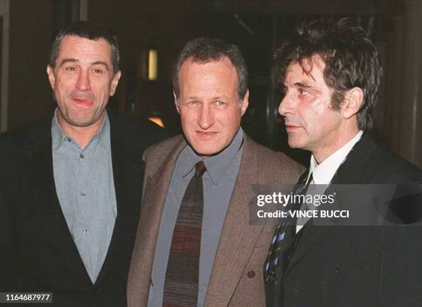 In this file photo taken on December 5, 1995 US actors Robert De Niro and Al Pacino pose with director Michael Mann as they arrive for the world...