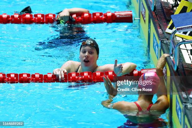 Lilly King of the United States and Yulia Efimova of Russia celebrate winning the gold and bronze respectively after competing in the Women's 50m...