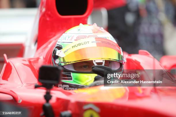 Mick Schumacher of Germany prepares to drive the Ferrari F2004 of his father, Michael Schumacher, before the F1 Grand Prix of Germany at...