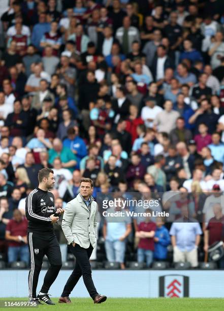 Scott Parker, Manager of Fulham walks to the dug out ahead of the Pre-Season Friendly match between West Ham United and Fulham at Craven Cottage on...