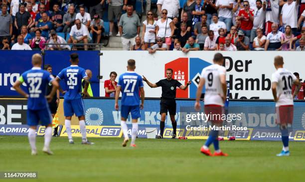 Players of Darmstadt protest to referee Robert Hartmann after the he awarded Darmstadt a penalty kick after consulting VAR during the Second...