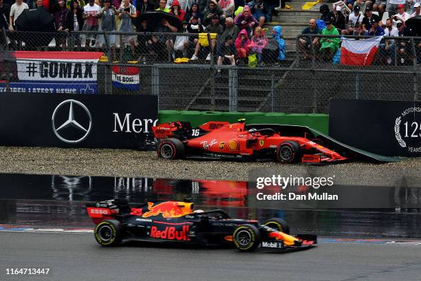 Max Verstappen of the Netherlands driving the Aston Martin Red Bull Racing RB15 passes as Charles Leclerc of Monaco driving the Scuderia Ferrari SF90...
